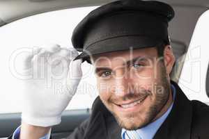 Handsome chauffeur smiling at camera