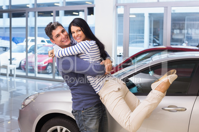 Smiling couple hugging and smiling at camera