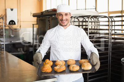 Baker showing tray of rolls Baker showing tray of rolls