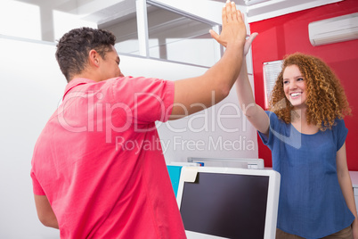 Smiling friends high fiving together Smiling friends high fiving together