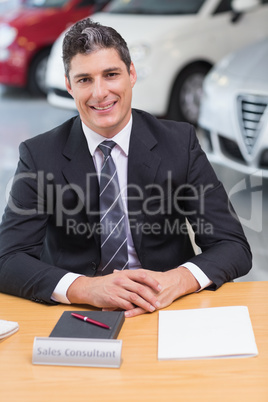 Cheerful businessman working at his desk