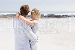 Cute couple hugging on the beach