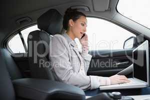 Businesswoman working in the passengers seat