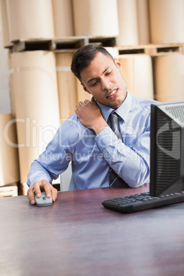 Warehouse manager working on computer