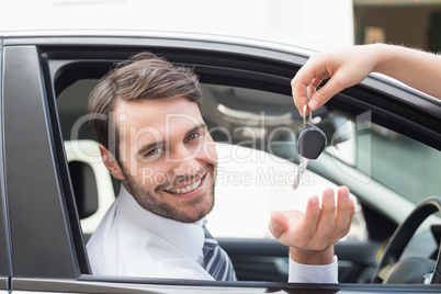 Businessman getting his new car key