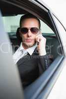 Businessman on the phone wearing sunglasses