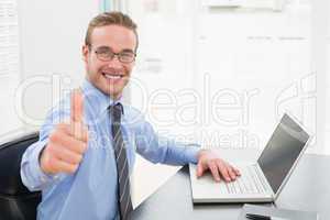 Positive businessman with glasses and thumb up