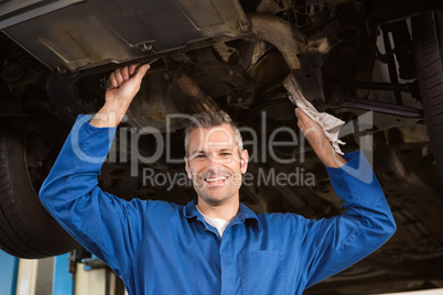 Mechanic examining under the car