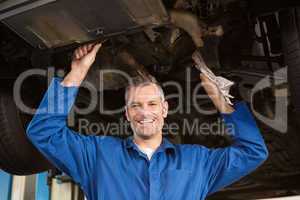 Mechanic examining under the car