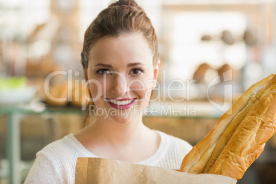 Pretty brunette with bag of bread