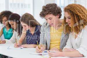 Fashion students taking notes in class