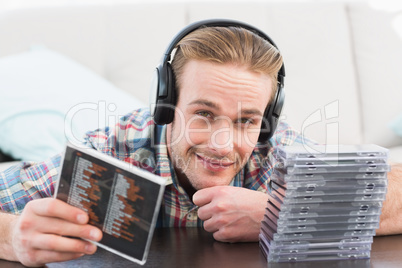 A man with headphones listening to cds