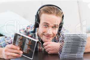 A man with headphones listening to cds