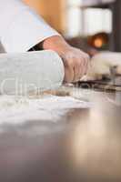 Close up of baker using a rolling pin