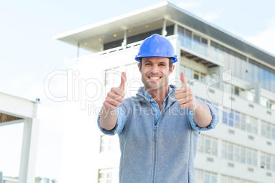 Confident male architect showing double thumbs up