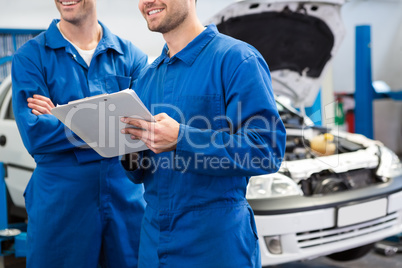 Smiling mechanic working together on clipboard