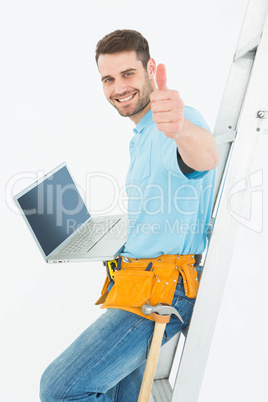 Construciton worker gesturing thumbs up while leaning on ladder