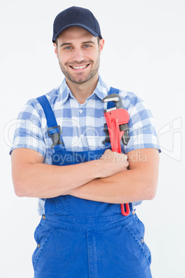 Confident young male repairman holding adjustable spanner