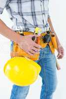 Technician with tool belt around waist and hard hat