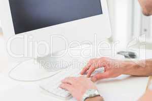 Businessman with watch typing on keyboard