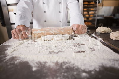 Close up of baker using a rolling pin