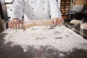 Close up of baker using a rolling pin