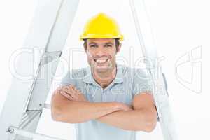 Happy carpenter leaning on step ladder