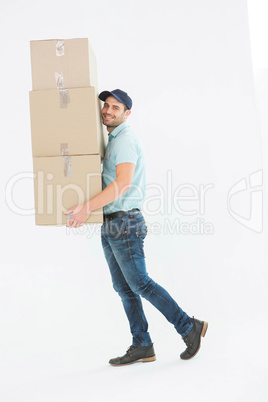 Delivery man carrying cardboard boxes