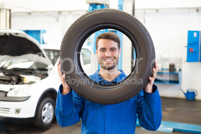 Mechanic holding a tire wheel