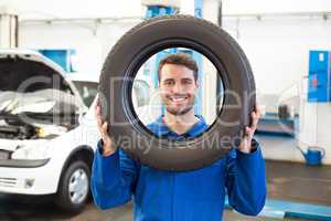 Mechanic holding a tire wheel