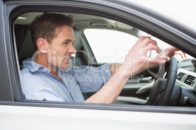 Handsome man experiencing road rage