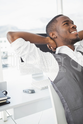 Relaxed businessman with hands behind head