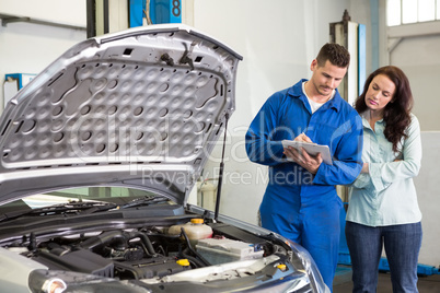 Customer listening to his mechanic Customer listening to his mechanic