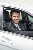 Happy businessman in the drivers seat