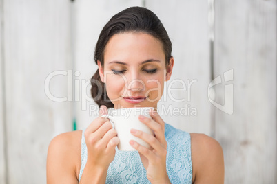 Stylish brunette holding a mug