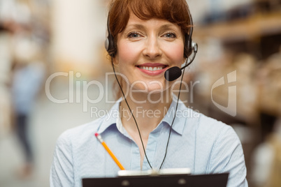 Manager wearing a headset while holding clipboard