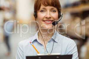 Manager wearing a headset while holding clipboard