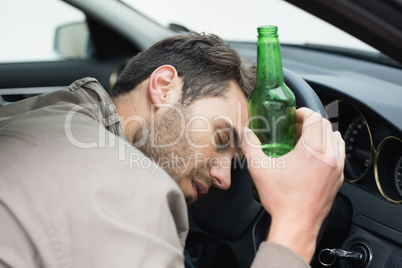 Man drinking beer while driving