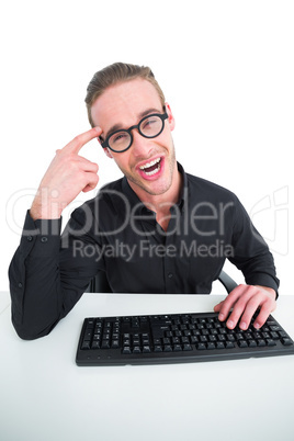 Businessman making a face and typing on keyboard