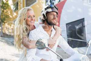 Attractive couple riding a scooter