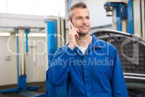 Smiling mechanic on the phone