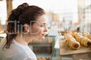 Woman eyeing up tray of pastrys