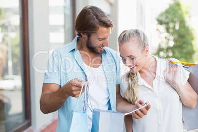 Attractive couple looking at shopping purchases
