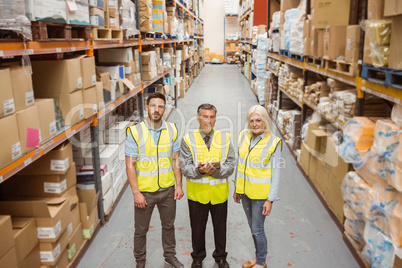 Warehouse team smiling at camera