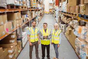 Warehouse team smiling at camera