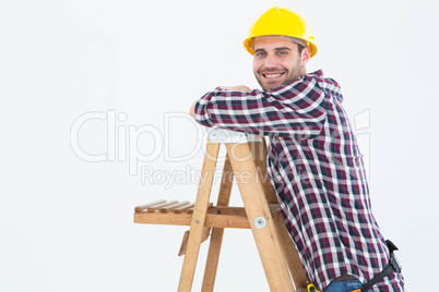 Smiling repairman climbing ladder