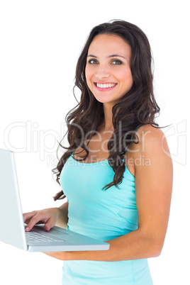 Casual brunette using her laptop