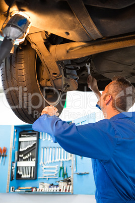 Mechanic examining under the car