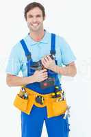 Confident carpenter holding drill machine