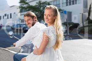 Attractive couple riding a scooter